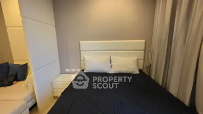 Cozy bedroom with modern decor and plush bedding in a stylish apartment.