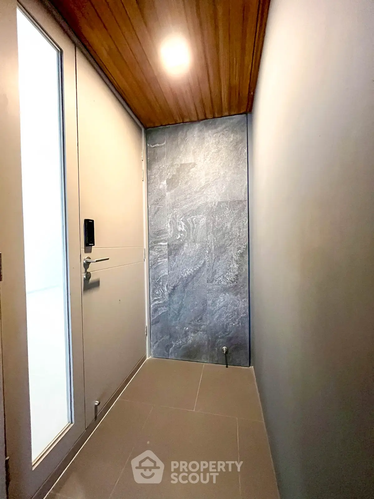 Modern entrance hallway with sleek design and wooden ceiling