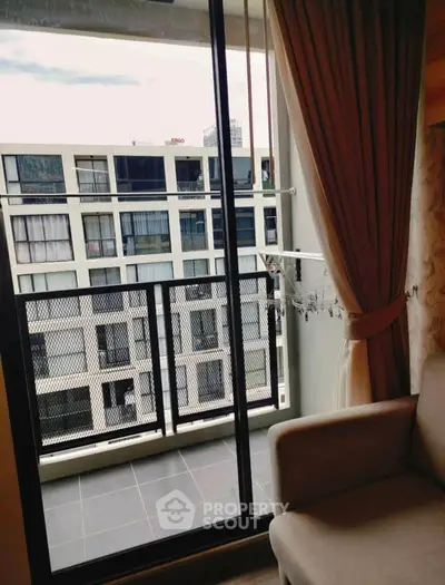 Modern apartment balcony with city view and sliding glass doors