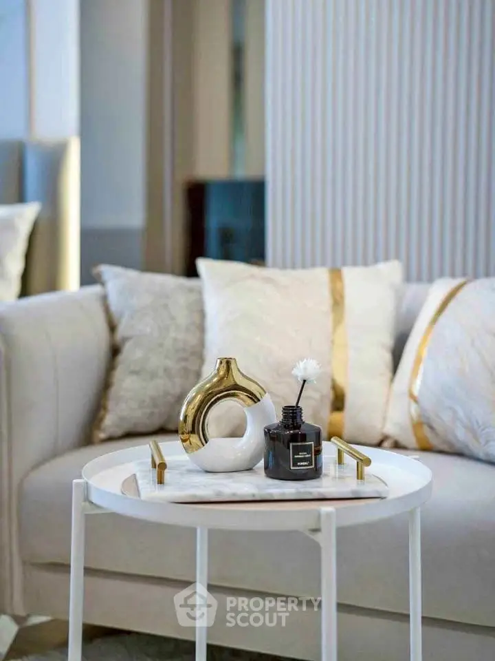 Elegant living room with modern decor and plush cushions on a stylish sofa, perfect for luxury living.