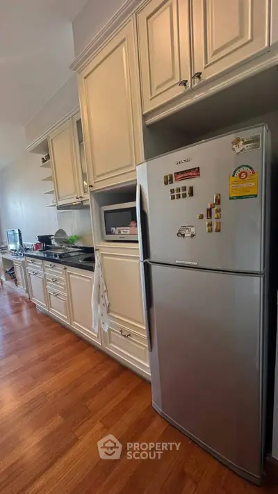 Spacious kitchen with modern appliances and elegant cabinetry, perfect for culinary enthusiasts.