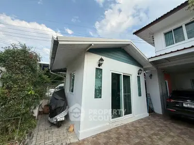 Charming small house with modern design and spacious driveway, perfect for cozy living.