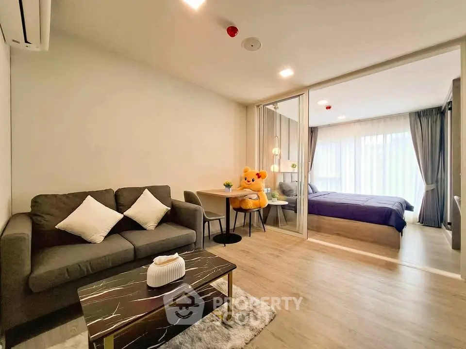 Modern open-plan living room with cozy bedroom and stylish decor