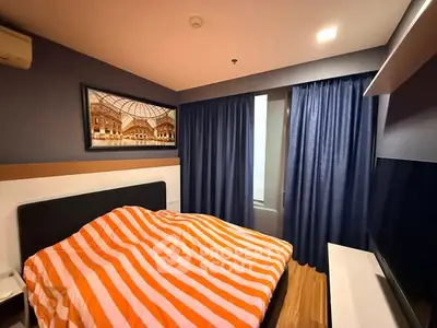 Cozy bedroom with striped bedding and modern decor