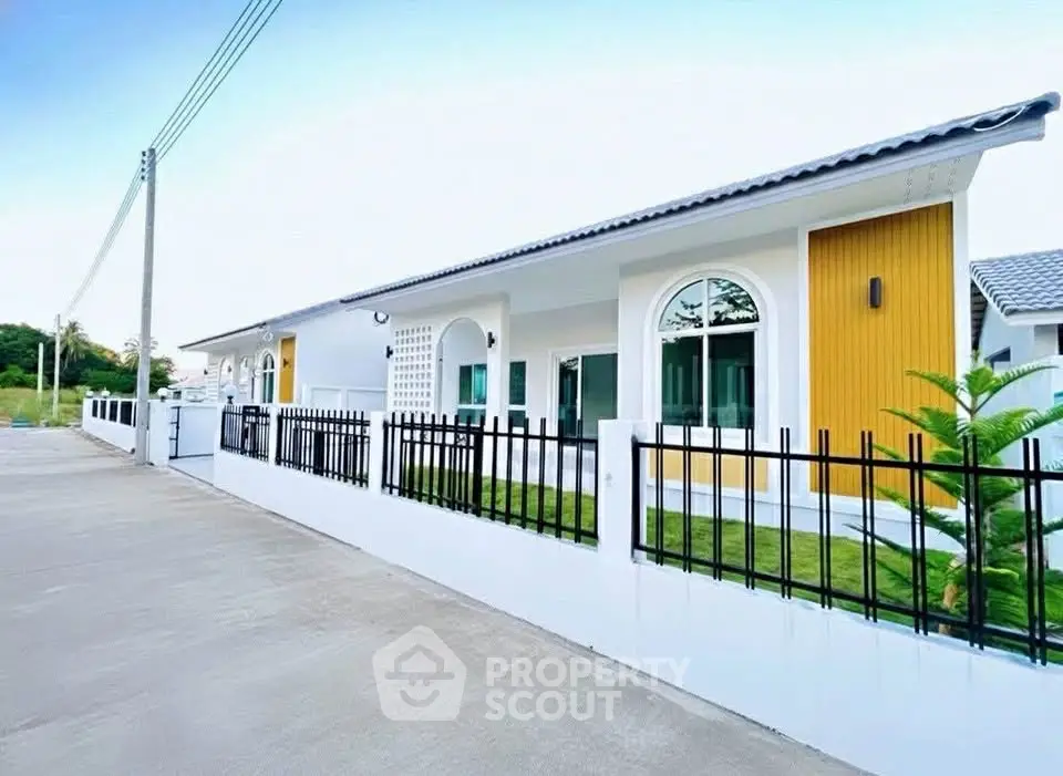 Modern single-story house with sleek design and fenced yard