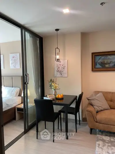 Modern apartment interior with cozy living room and dining area, featuring elegant decor and natural lighting.