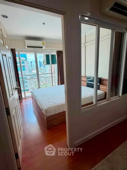 Spacious bedroom with city view and large windows in modern apartment