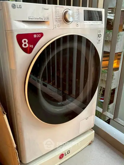 Modern LG washing machine on apartment balcony, showcasing efficient laundry solution in urban living space.