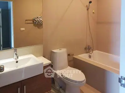 Modern bathroom with bathtub and sleek fixtures in a contemporary apartment.