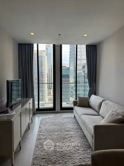 Modern living room with stunning city view, featuring sleek furniture and floor-to-ceiling windows.