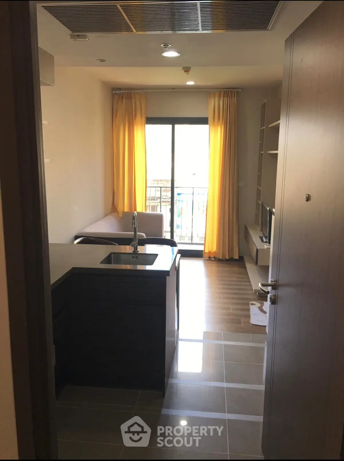 Modern apartment interior with open kitchen and balcony view