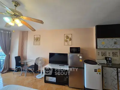 Charming living room with modern appliances and balcony view, perfect for cozy urban living.