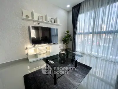 Modern living room with sleek TV setup and large window view