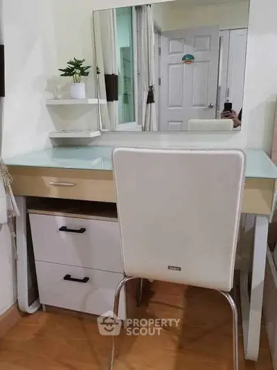 Stylish study area with modern desk and chair in a cozy room.