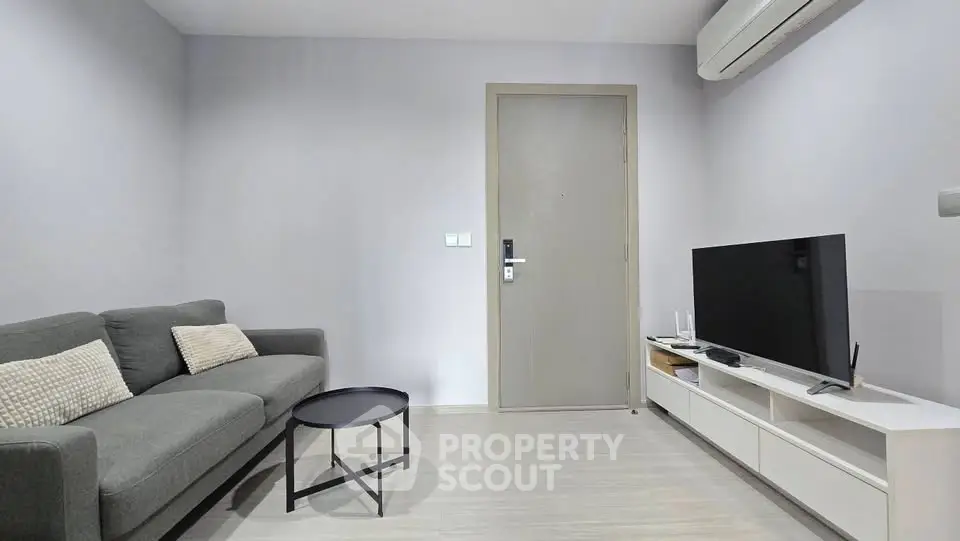 Modern living room with sleek furniture and air conditioning, perfect for comfortable living.