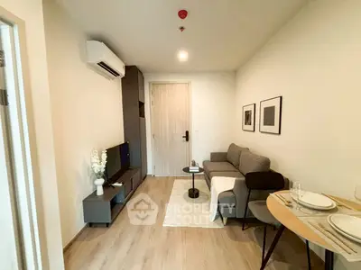 Modern living room with cozy sofa and stylish decor in a compact apartment.