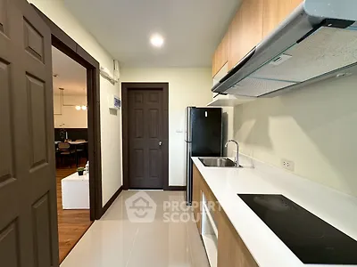 Modern kitchen with sleek appliances and open layout in stylish apartment