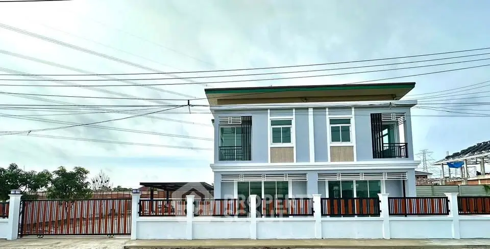 Modern two-story house with sleek design and spacious outdoor area.