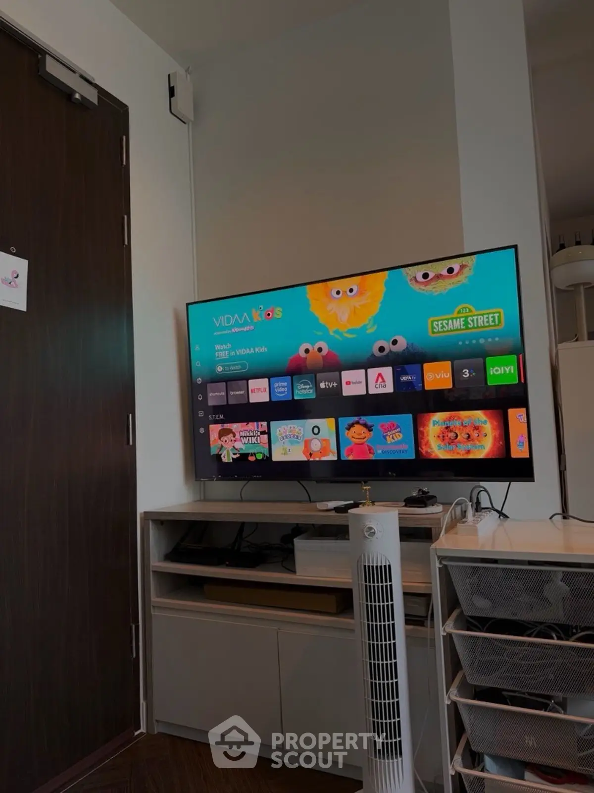 Modern living room with smart TV and sleek storage solutions.