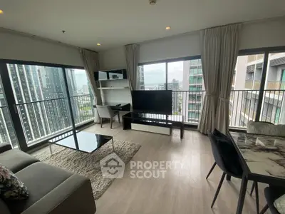 Modern living room with panoramic city views and stylish furnishings.