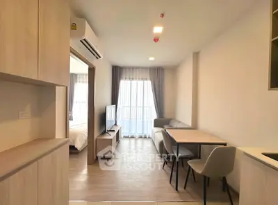 Modern open-plan living room with dining area and natural light