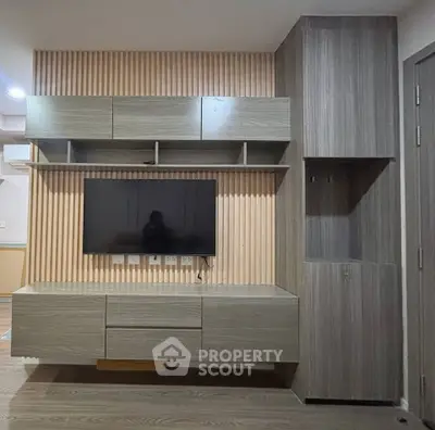 Modern living room with sleek TV unit and ample storage space