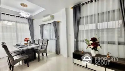 Elegant dining and living space with sleek furniture, polished floors, and tasteful decor, perfect for modern living.