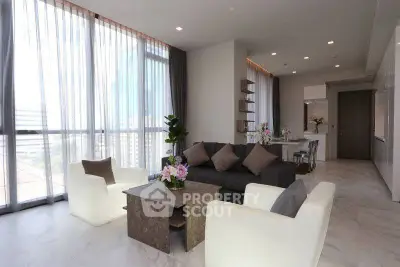 Spacious modern living room with elegant decor and large windows