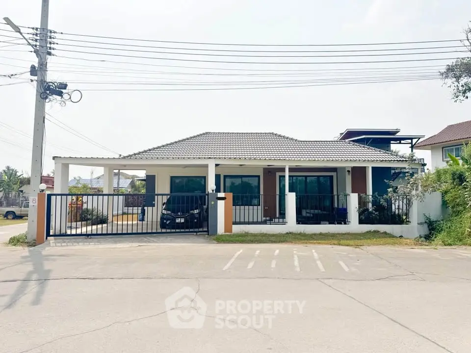 Charming single-story house with gated driveway and spacious front yard in a serene neighborhood.