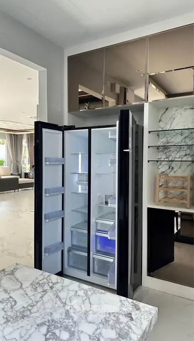 Luxurious modern kitchen with open fridge and marble countertops