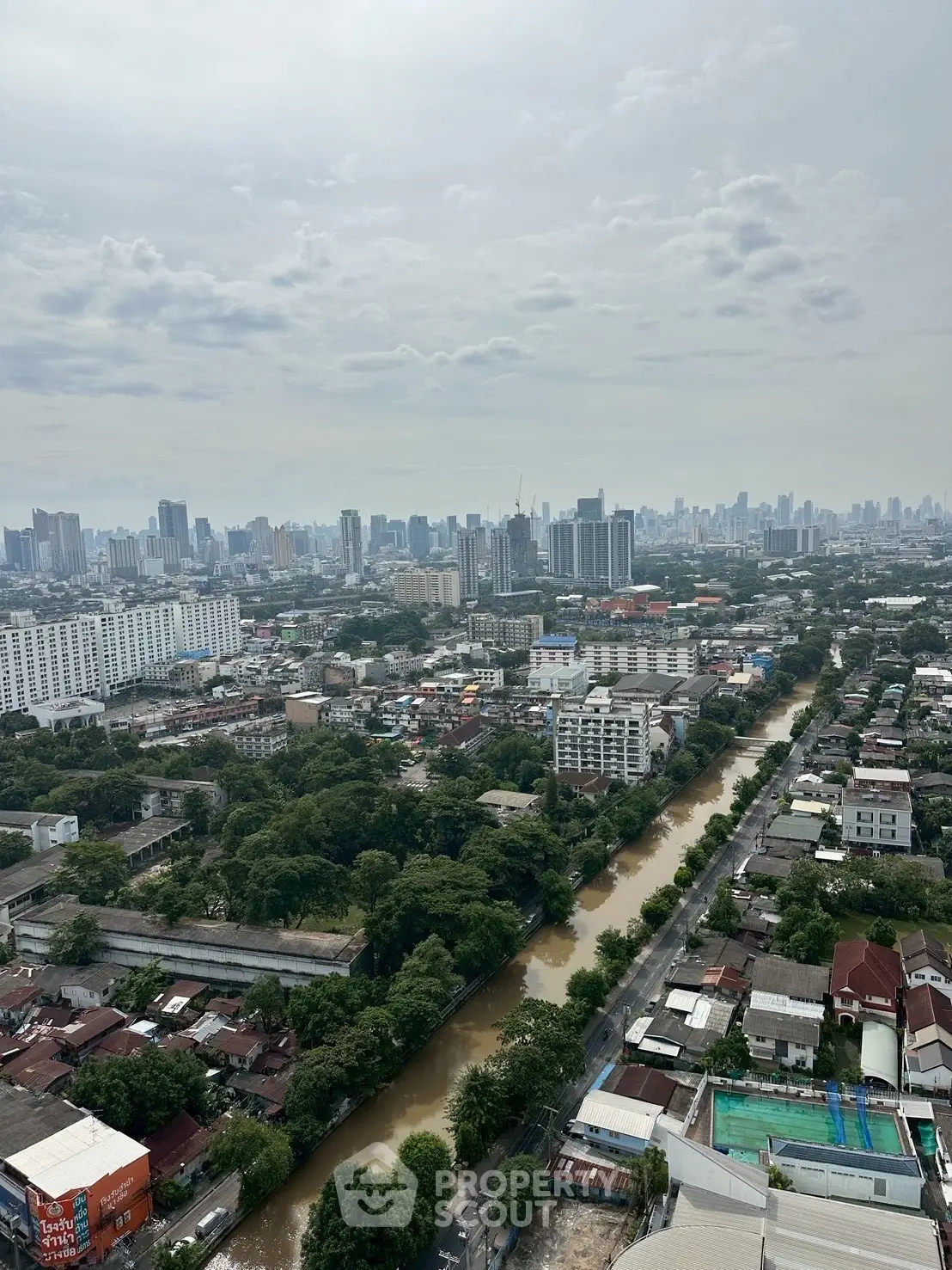 Stunning cityscape view from high-rise building overlooking urban skyline and river.