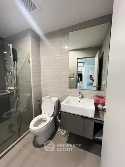 Modern bathroom with glass shower and sleek vanity