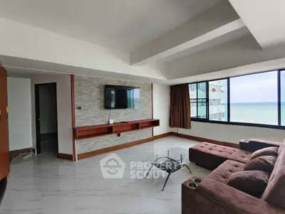 Spacious living room with ocean view and modern furnishings