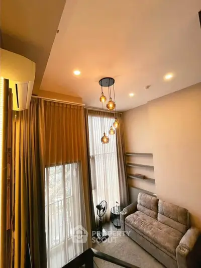 Modern living room with high ceiling and stylish lighting