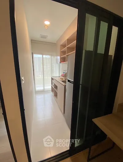Modern kitchen with sliding glass door and ample natural light