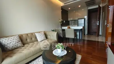 Modern living room with elegant sofa and open kitchen layout in a stylish apartment.