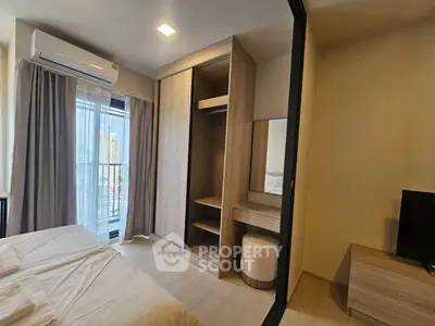 Modern bedroom with balcony view and built-in wardrobe in a stylish apartment.