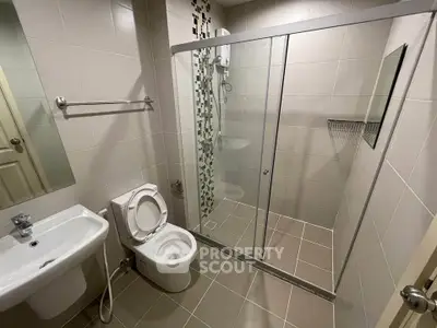 Modern bathroom with glass shower enclosure and sleek tile design