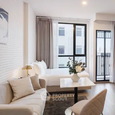 Modern studio apartment with elegant decor and balcony view