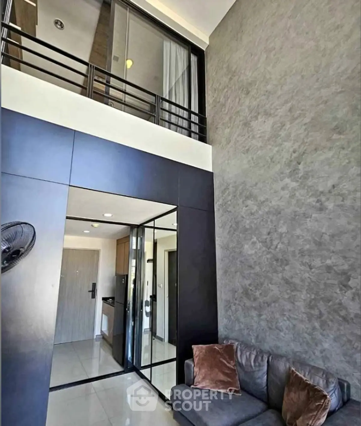 Modern loft-style living room with high ceiling and sleek design