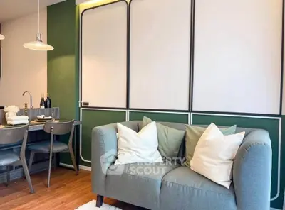 Stylish living room with modern green and white decor, cozy sofa, and elegant dining area.