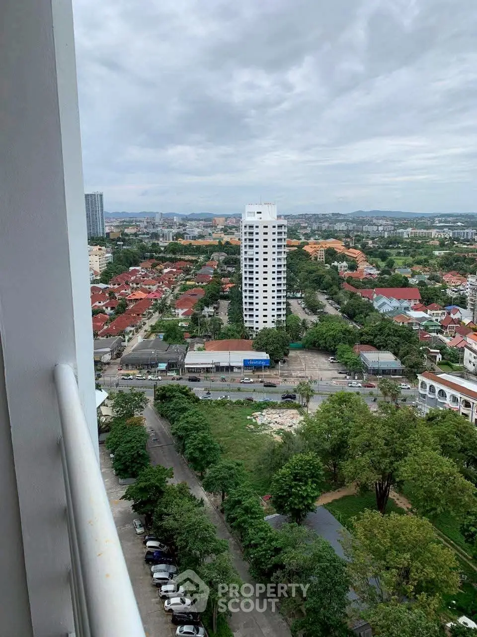 Stunning cityscape view from high-rise balcony overlooking urban landscape.