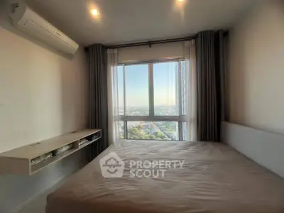 Modern bedroom with large window offering stunning city view