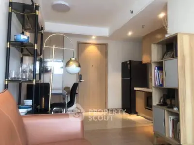 Modern living room with stylish furniture and open kitchen layout in a cozy apartment.