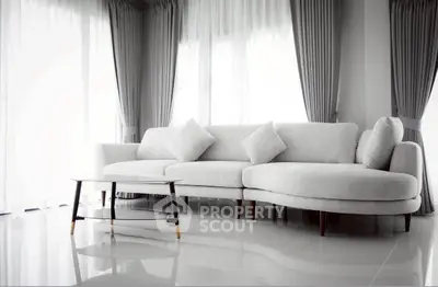 Elegant living room with modern white sofa and stylish curtains, perfect for contemporary home decor.