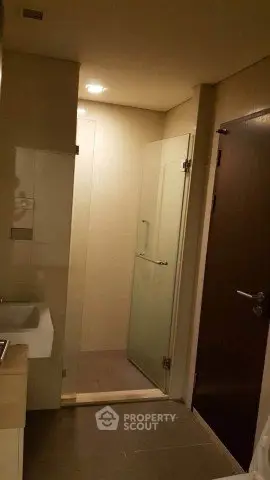 Modern bathroom with glass shower door and sleek fixtures