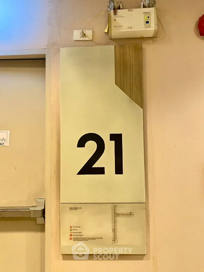 Floor 21 sign in modern building with emergency exit plan