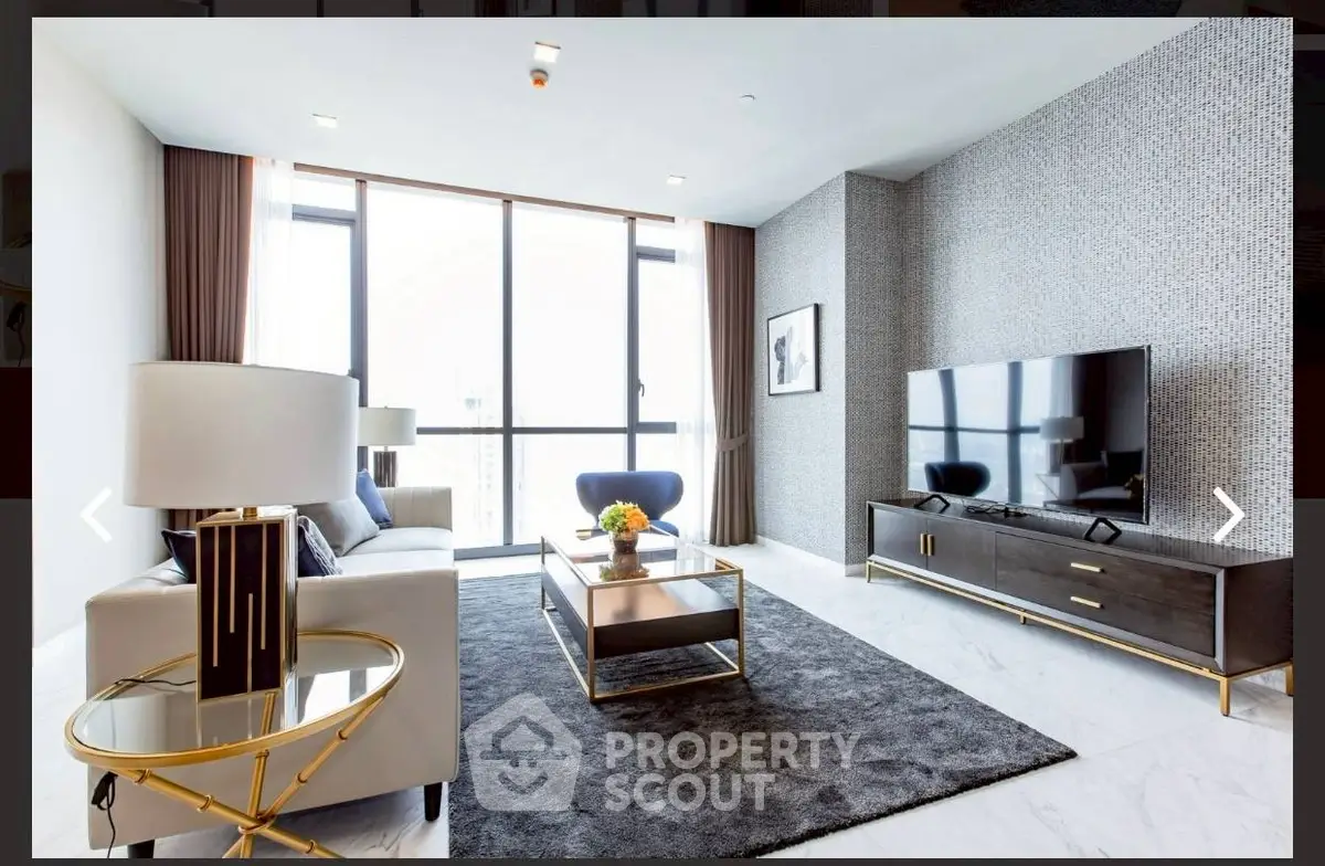 Luxurious modern living room with elegant decor and large windows offering natural light.
