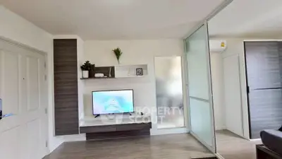 Modern living room with sleek TV setup and sliding glass door