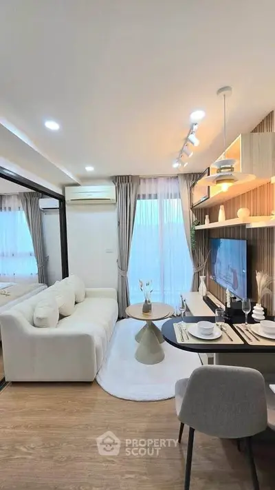 Modern living room with stylish decor, cozy seating, and elegant lighting in a contemporary apartment.